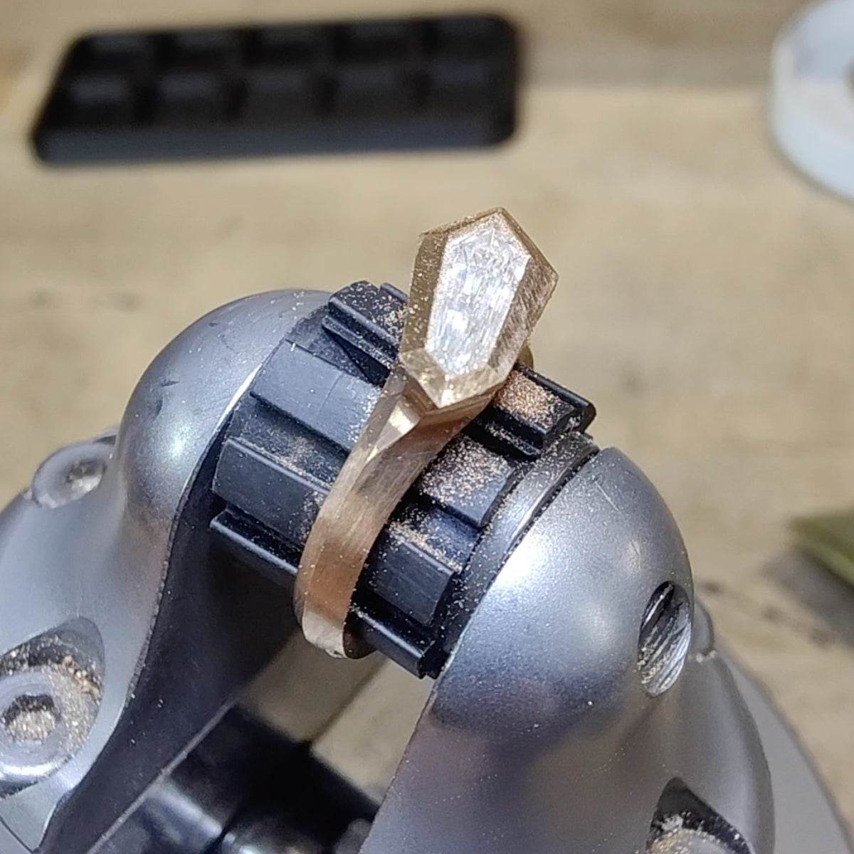 Aegis shield shaped diamond being set in 18ct gold