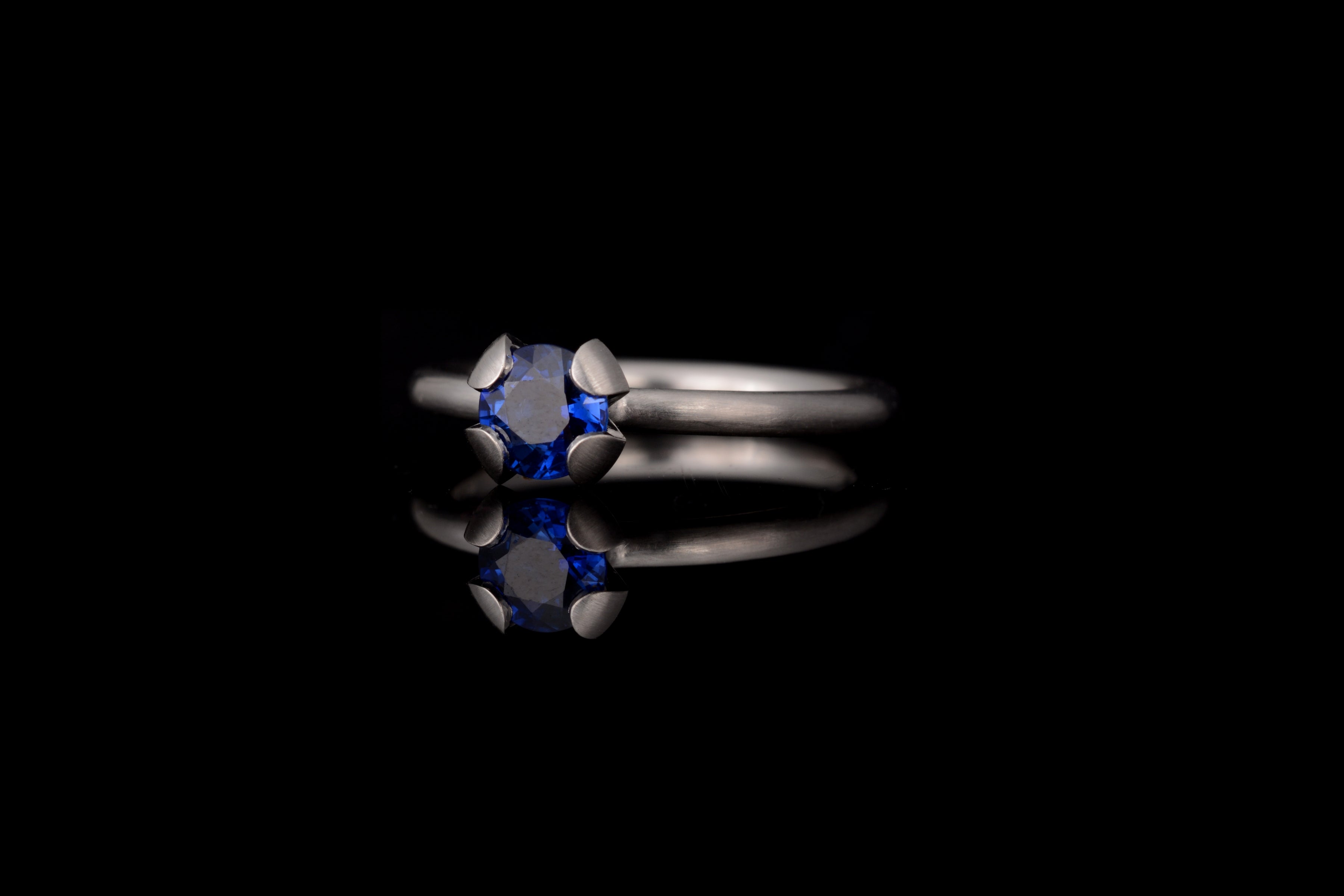 Platinum Calyx engagement ring with blue sapphire