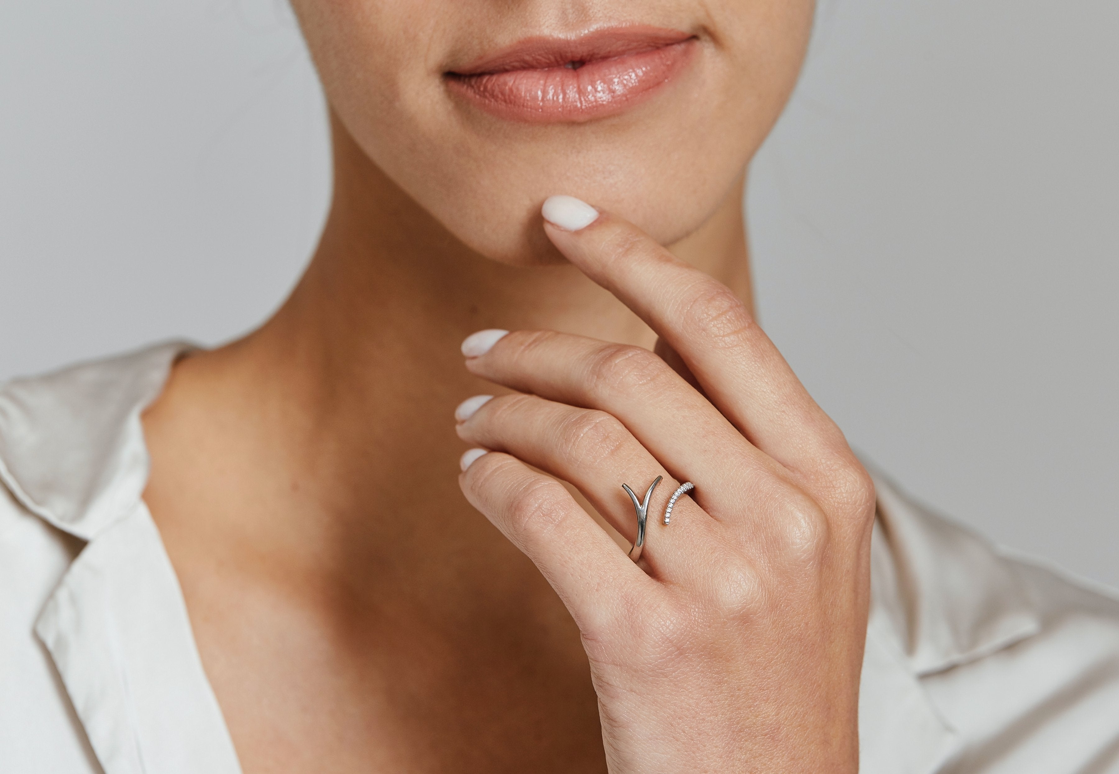 White gold and diamond hand forged open ring on the hand